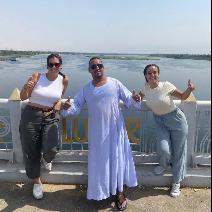 Tito, official taxi driver, with tourists on Luxor Bridge over the Nile