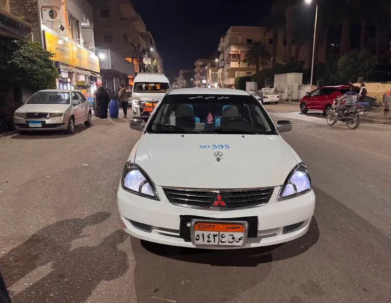 Tito's taxi car at night in Luxor